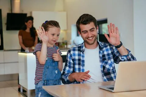 Work from home. Daughter interrupting her father while he is having a business Stock Photos
