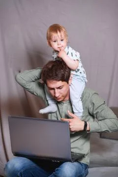 Work from home. This is a developer for working on a laptop with children in  Stock Photos