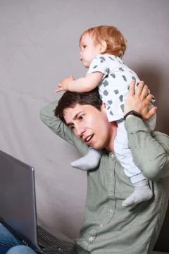 Work from home. This is a developer for working on a laptop with children in  Stock Photos
