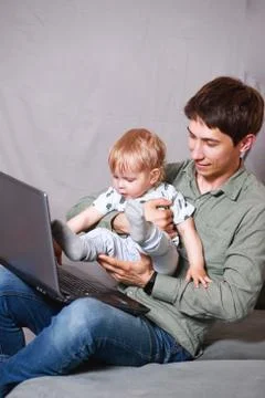 Work from home. This is a developer for working on a laptop with children in  Stock Photos