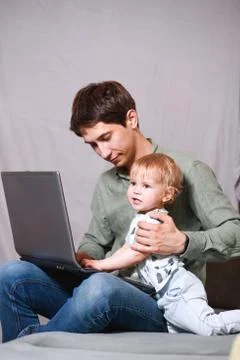 Work from home. This is a developer for working on a laptop with children in  Foto stock