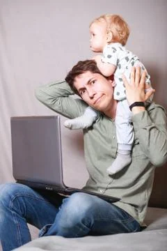 Work from home. This is a developer for working on a laptop with children in  Stock Photos