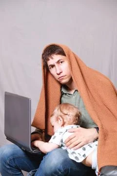 Work from home. This is a developer for working on a laptop with children in  Foto stock