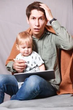 Work from home. This is a developer working on a tablet computer with childre Foto stock