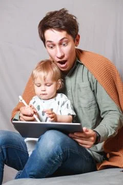 Work from home. This is a developer working on a tablet computer with childre Foto stock