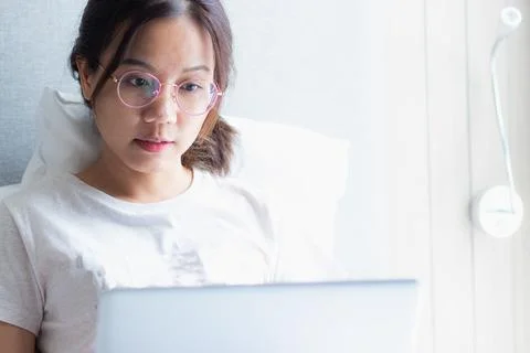 Work from home during the outbreak of the virus. Asian young woman seriousl.. Stock Photos