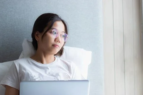 Work from home during the outbreak of the virus. Asian young woman seriousl.. Stock Photos