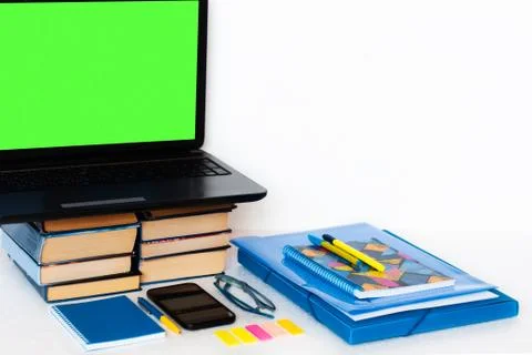 Work from home, mobile, green screen laptop computer, books and notebook. Edu Stockfoto's