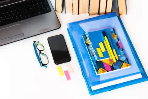 Work from home, mobile, laptop computer, books and notebook. Education backgr Stock Photos