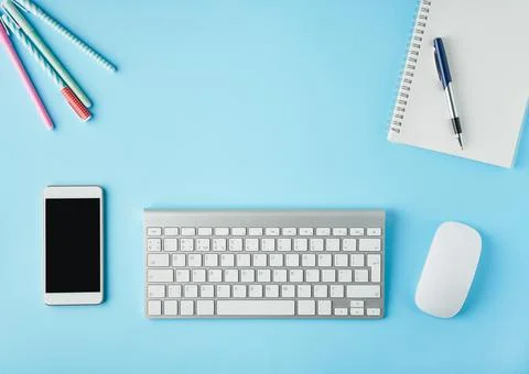 Work from home, online learning. Bright blue modern desk. Top view. Distance Stock Photos