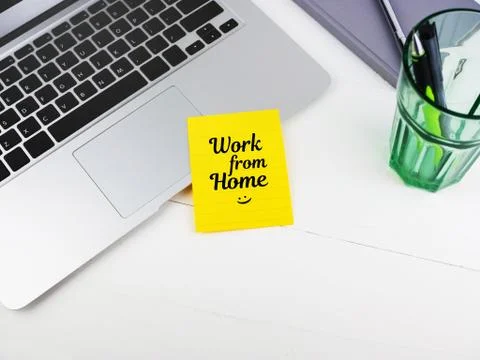 Work from home on sticky note on desk Stock Photos