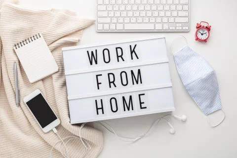 Work from home word on lightbox with working stuff and mask, quarantine for c Stock Photos