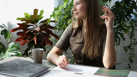 Work at home. young beautiful freelancer woman is working at the table Vídeos de archivo 88193094