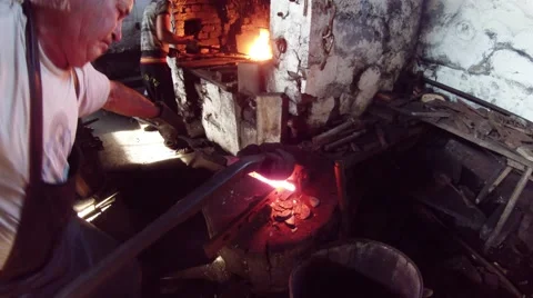 Work with hot metals in the old smithy in the glow and smoke Stock Footage 46422189