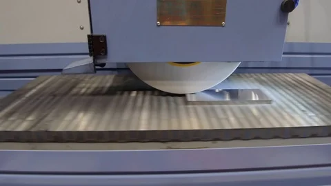 Work of an industrial surface grinding machine. Grinding of a flat metal part. Stock Footage 98858847
