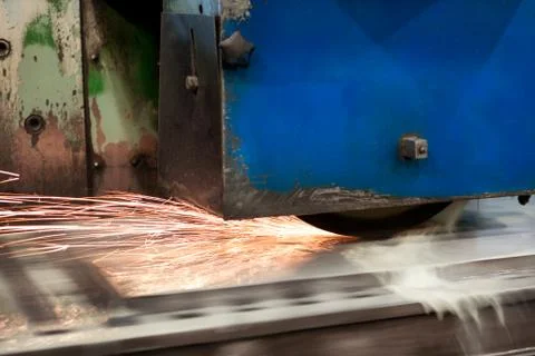 Work of an industrial surface grinding machine. Grinding of a flat metal part Stock Photos