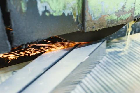 Work of an industrial surface grinding machine. Grinding of a flat metal part Stock Photos