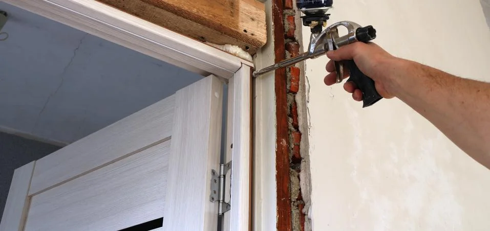 The work of the installer to fix the door frame Stock Photos