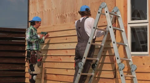Work on Installing Siding Stock Footage 56636397