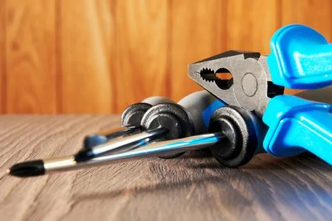 Work instruments with screwdriver and pliers on the wooden display Stock Photos