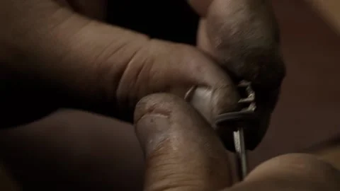 The work of a jeweler. Handmade. Making a white gold ring. Polishing the ring Video stock 153154772