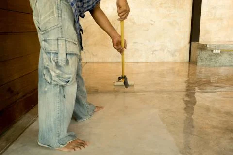 Work Lacquering concrete floors using roller for coating Stock Photos