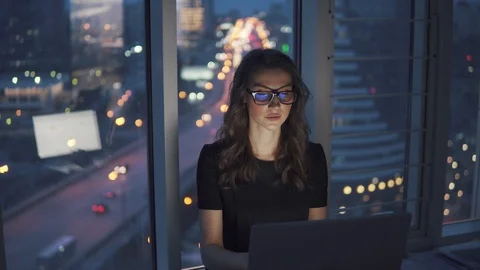 Work late at night in the office. young woman in business suit and glasses works Stock Footage 105941531