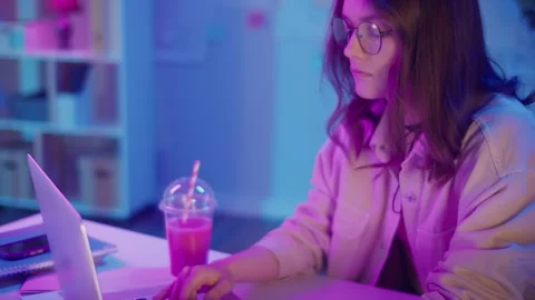 Work-Life Blend, Gen Z Focus, Creative Flow. Woman Works and Drinks Pink Juice Stock Footage 307069075