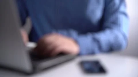 Work in a Light Modern Office. Young Modern Man Working on Laptop. Blurred Video Stock Footage 150376903