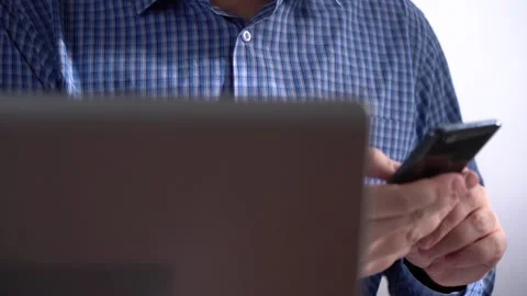 Work in a Light Modern Office. Young Modern Man Holding a Smartphone. Stock Footage 150376927