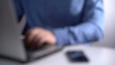 Work in a Light Modern Office. Young Modern Man Working on Laptop. Blurred Video Stock Footage 156999013