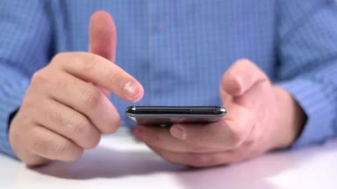 Work in a Light Modern Office. Young Modern Man Holding a Smartphone. Video stock 166514453