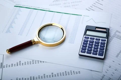 Work with a magnifying glass, a calculator 库存照片