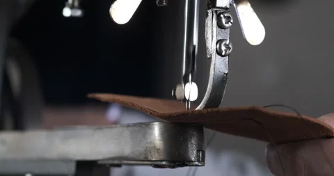 Work of Mechanism of Old Sewing Machine. Makes Seam on Treated Natural Leather Stock Footage 148312905