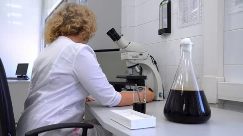 Work with a microscope Stock Footage 121585115