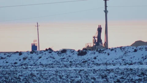 The work of a mining excavator on the background of the winter sunset 4K Stock Footage 99098387