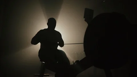 Work on the muscles of the back. Men working out on rowing machine in gym. Men Vídeo Stock 105739293