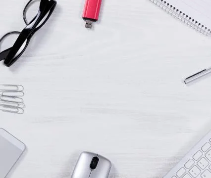 Work objects in circle pattern on white desktop Stock Photos