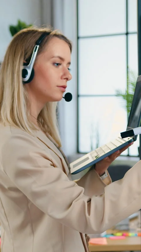 Work in office concept where business woman office worker in wireless headset Stock Footage 329187612