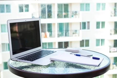 Work office desk with a computer laptop, notebook, pen on the glass table. Foto stock