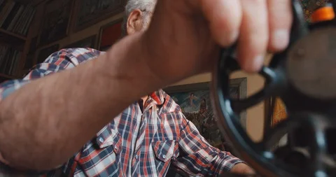 Work on the old sewing machine. Aged senior man with gray beard sewing. 4k Stock Footage 123503629