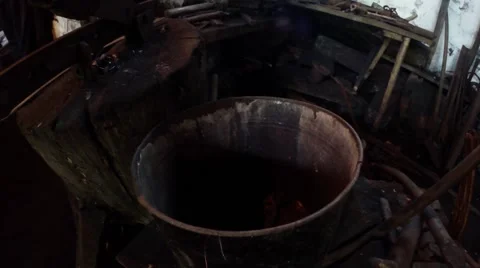 Work in the old smithy, a piece of hot metal falls in a special bucket Stock Footage 46466153