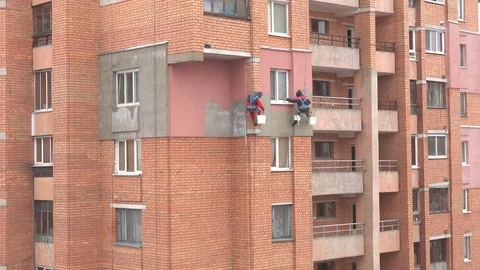 Work on the outer insulation of an apartment house Stock Footage 70582236