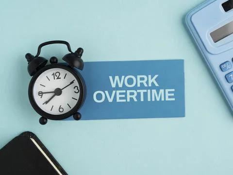 Work overtime concept with an alarm clock, calculator, pen, and document, r.. 库存照片