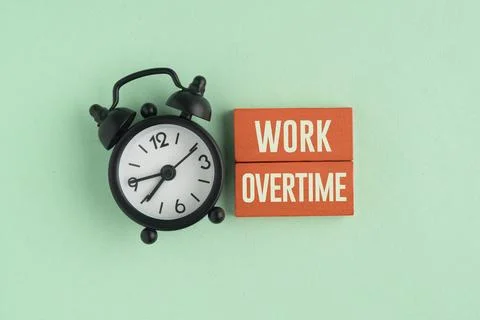 Work overtime concept with an alarm clock, calculator, pen, and document, r.. Stock Photos