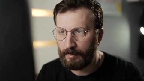 Work on PC, research, remote worker concept. Man puts on glasses and starts typi Видео 303948245