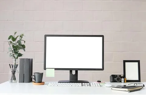Work place with blank screen computer pc and office supplies on white table.. Stock Photos