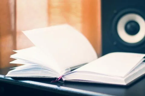 Work place with notebook or book on surround sound column background Stock Photos