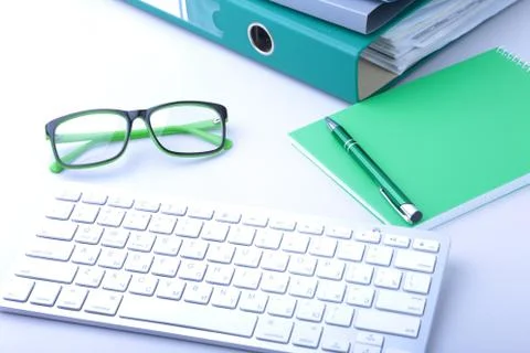 Work place table with folders file on it and modern laptop, pen, glasses and Stock Photos