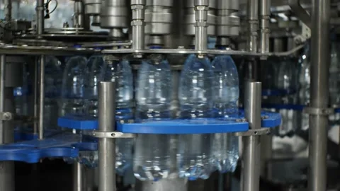 The work of the plastic bottle capping machine at the plant for the production Stock Footage 165321188